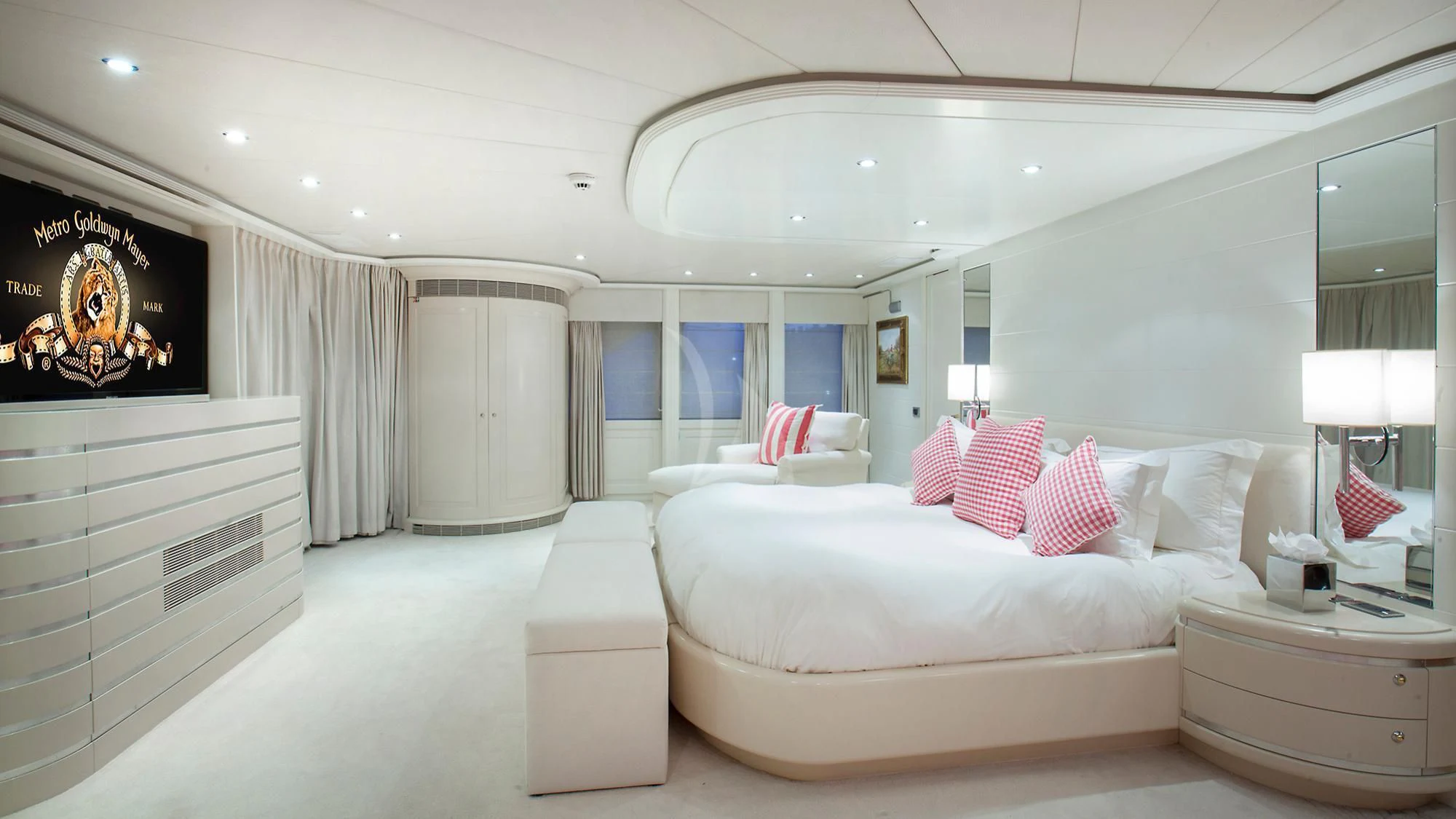 a room with a bed and a television aboard BENIK Yacht for Charter