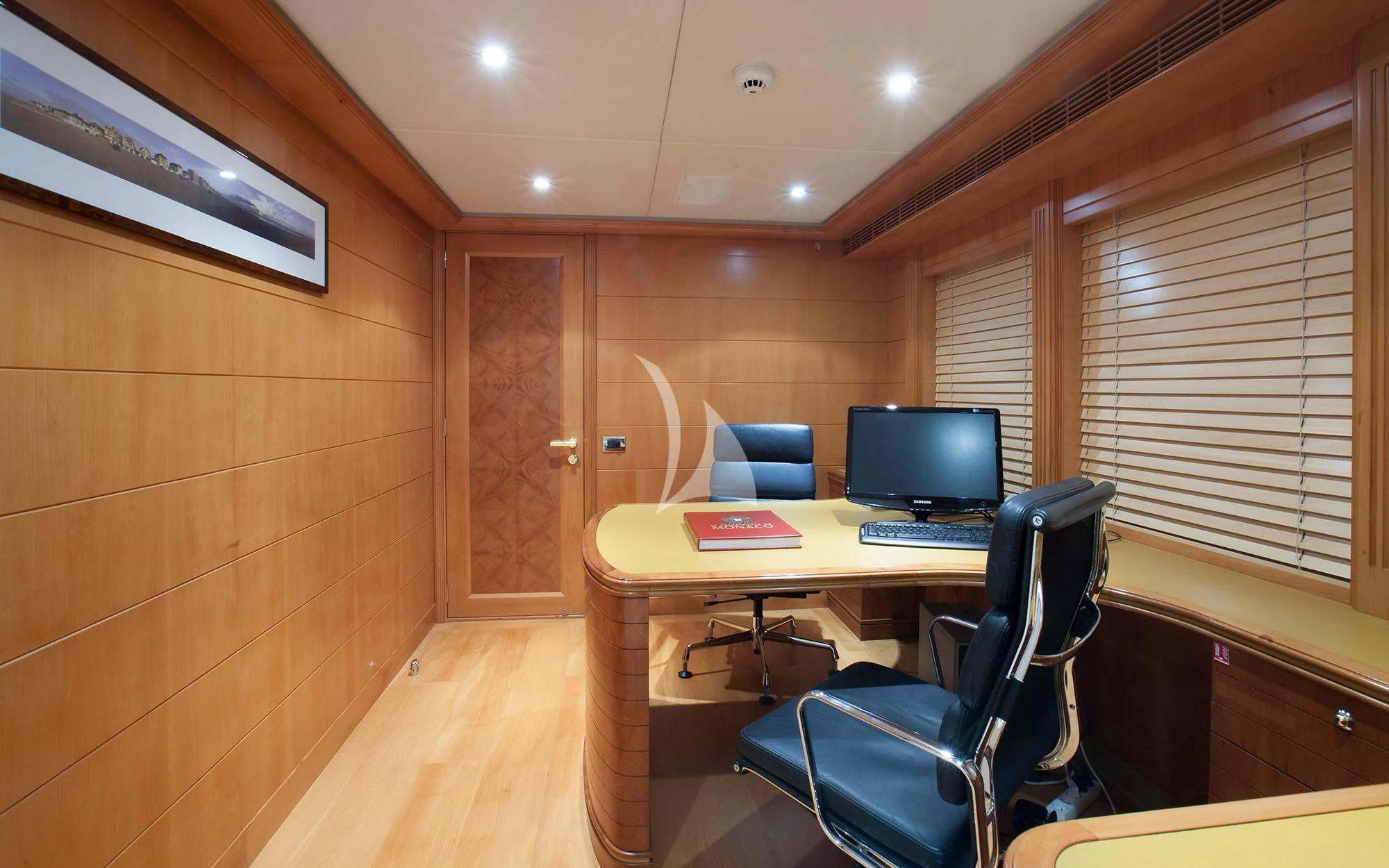 a room with a desk and a computer aboard BENIK Yacht for Charter
