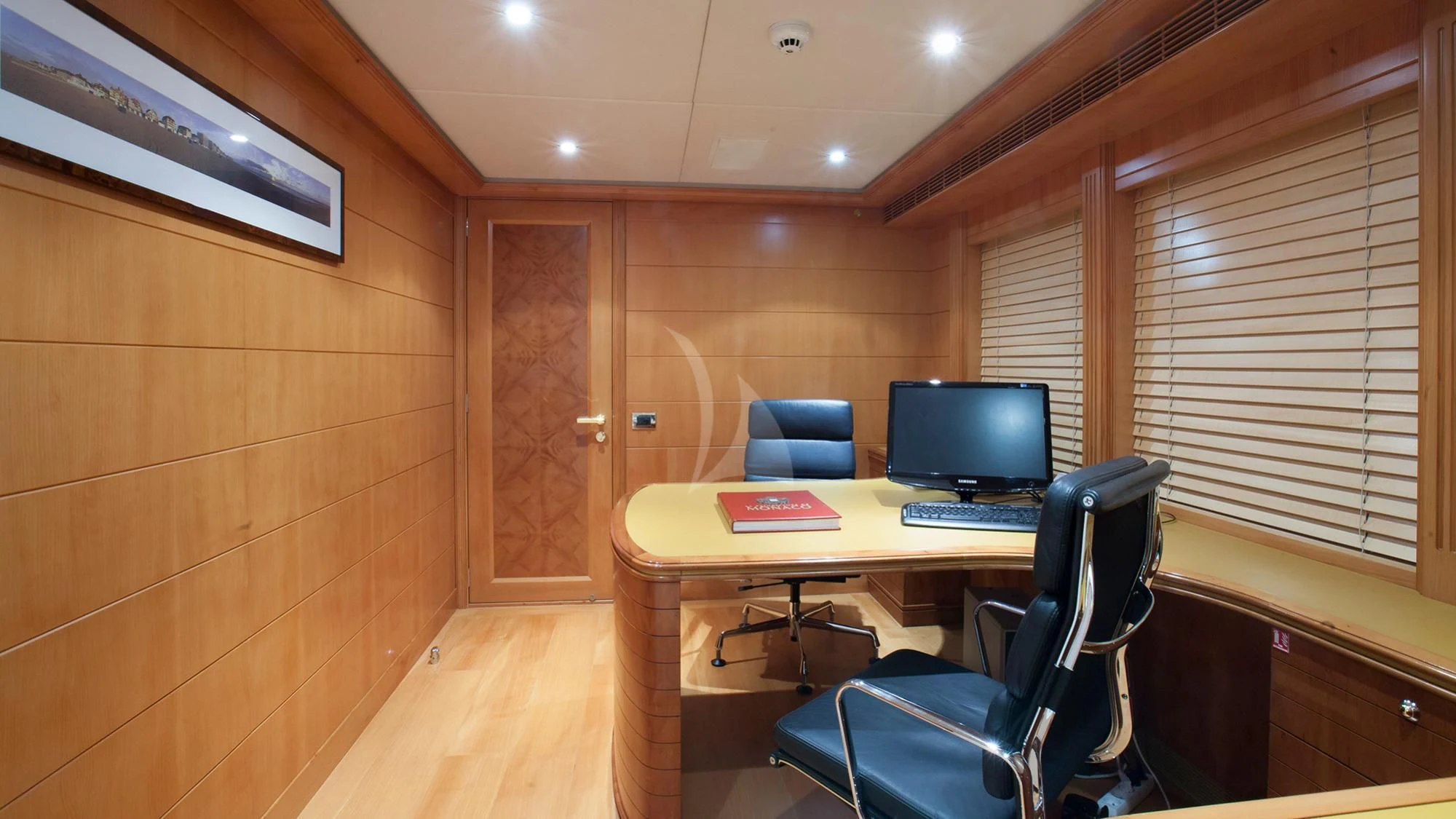 a room with a desk and a computer aboard BENIK Yacht for Charter