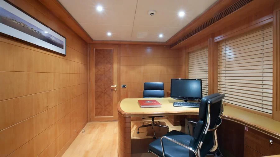 a room with a desk and a computer aboard BENIK Yacht for Charter