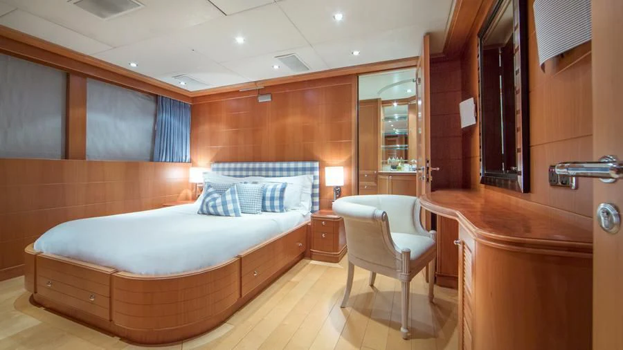 a room with a bed and a chair aboard BENIK Yacht for Charter
