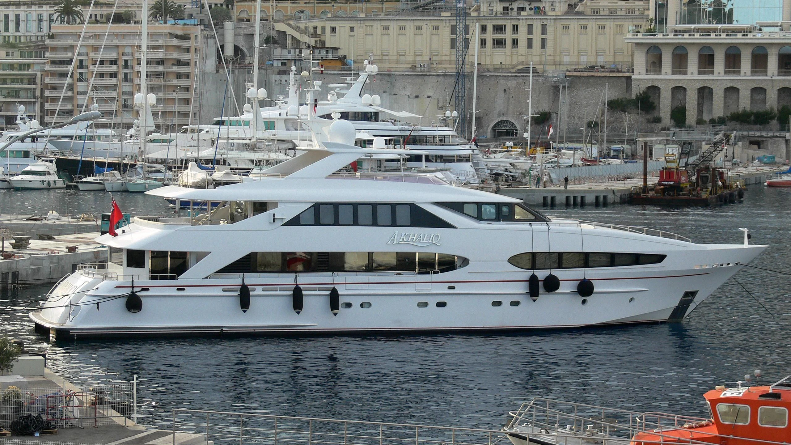 a white yacht in a harbor aboard BENIK Yacht for Charter