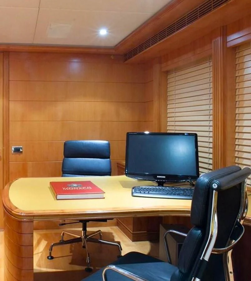 a desk with a computer and a chair aboard BENIK Yacht for Charter