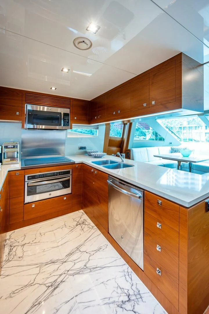 a kitchen with wooden cabinets aboard MOIRA CINCO Yacht for Sale