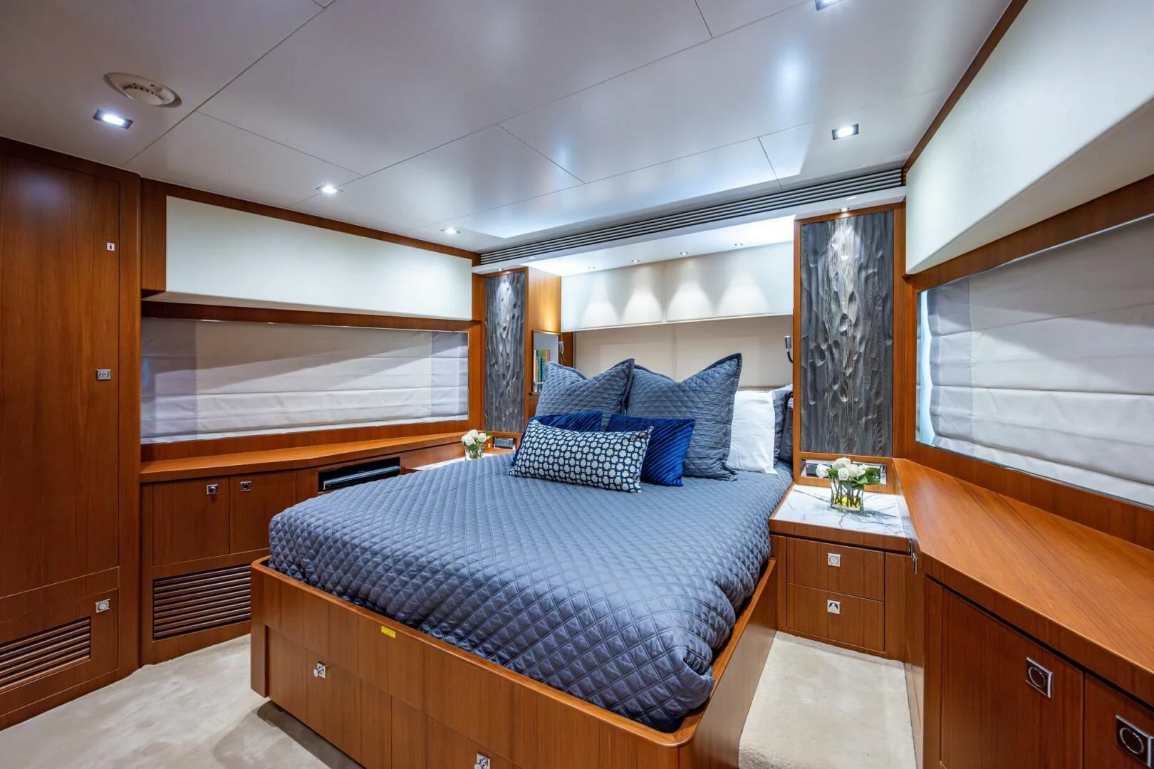 a bedroom with a bed and cabinets aboard MOIRA CINCO Yacht for Sale