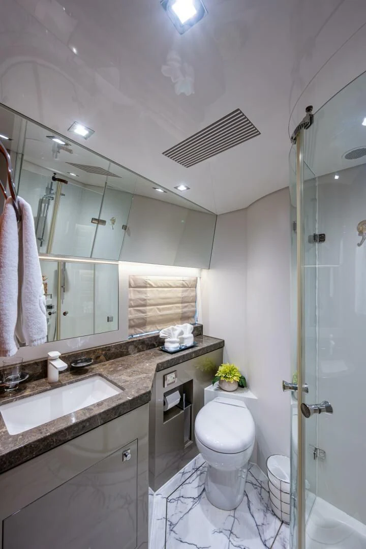 a bathroom with a toilet sink and a mirror aboard MOIRA CINCO Yacht for Sale