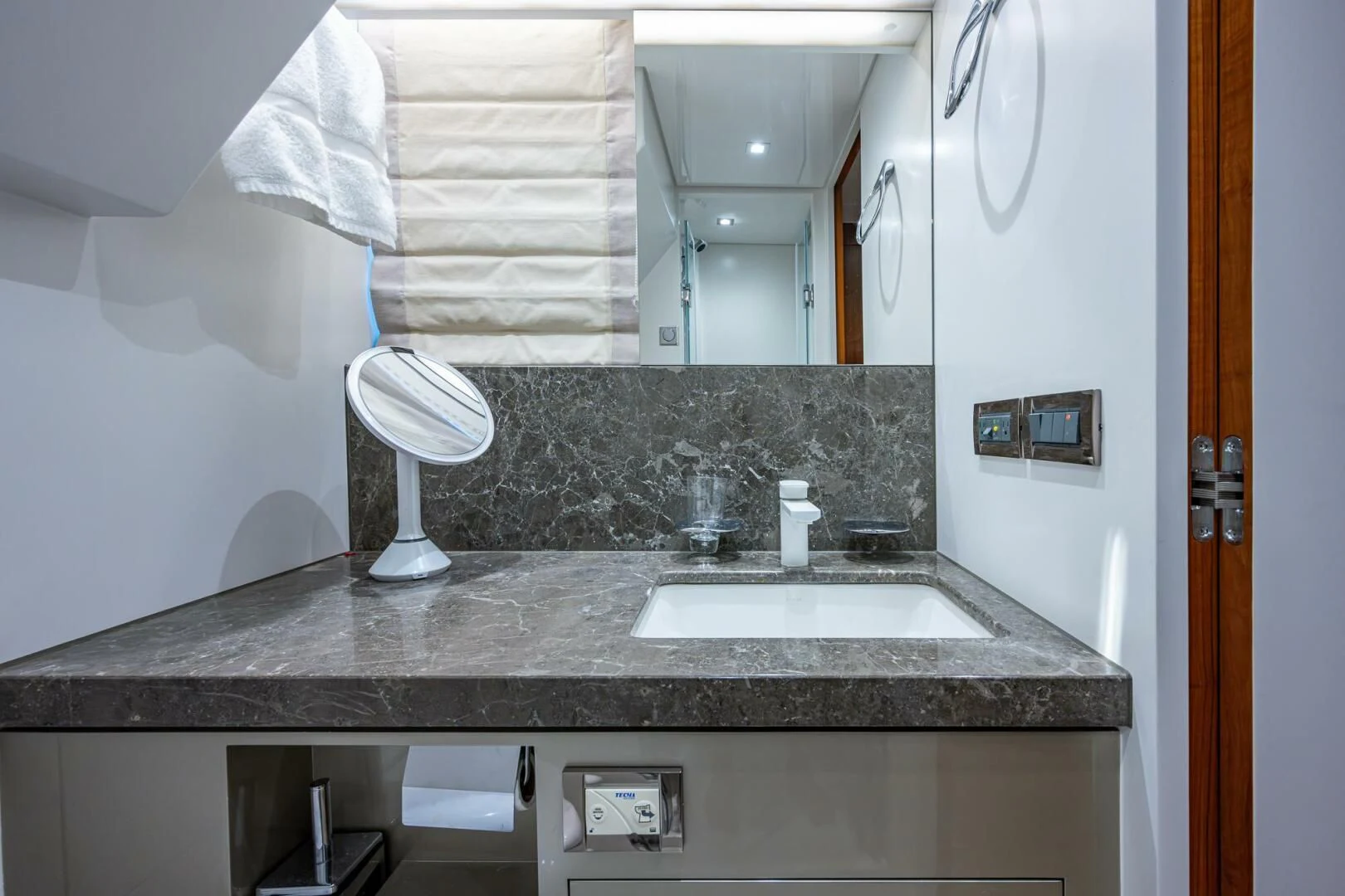 a bathroom with a countertop sink and mirror aboard MOIRA CINCO Yacht for Sale