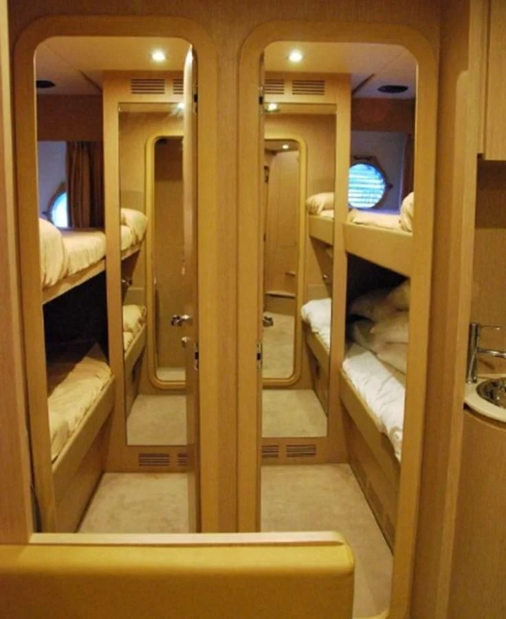 a room with a bed and a mirror aboard MOIRA CINCO Yacht for Sale