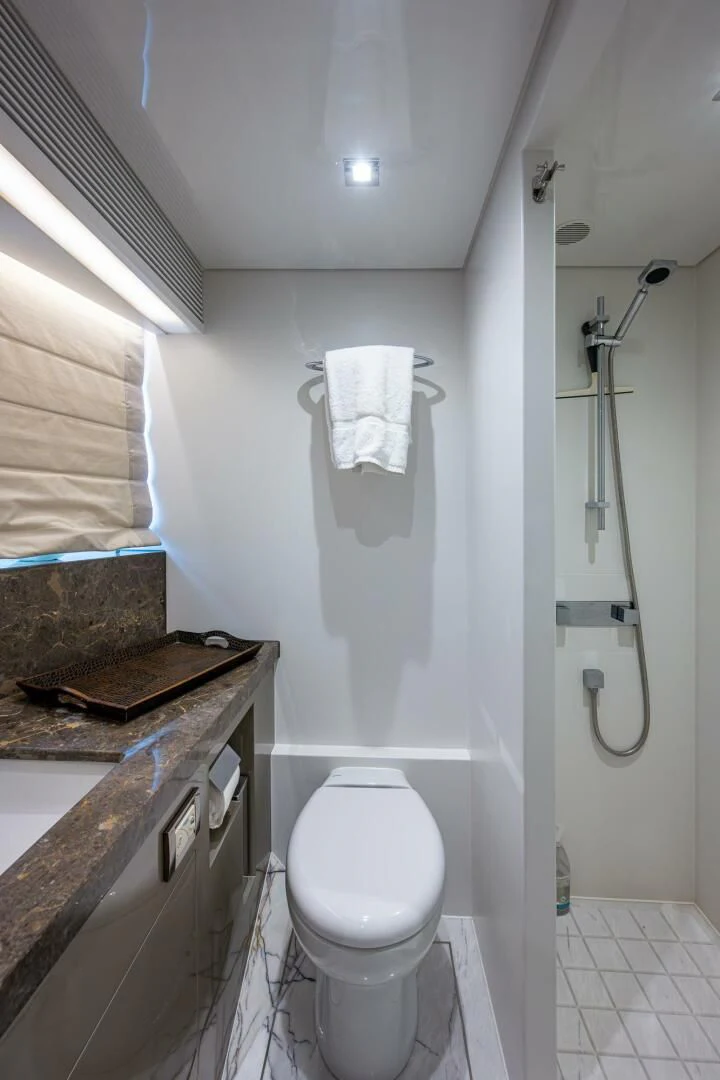 a bathroom with a toilet and a sink aboard MOIRA CINCO Yacht for Sale