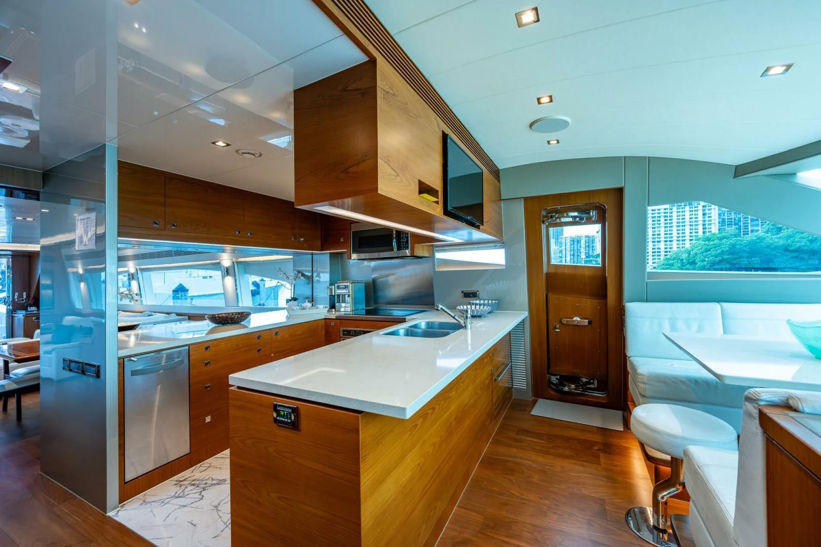 a kitchen with a large wooden island aboard MOIRA CINCO Yacht for Sale