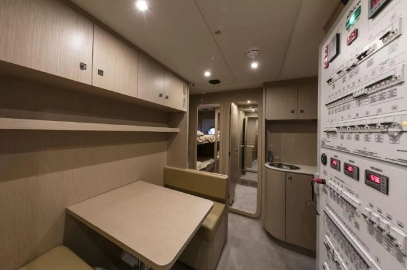 a kitchen with a table and refrigerator aboard MOIRA CINCO Yacht for Sale