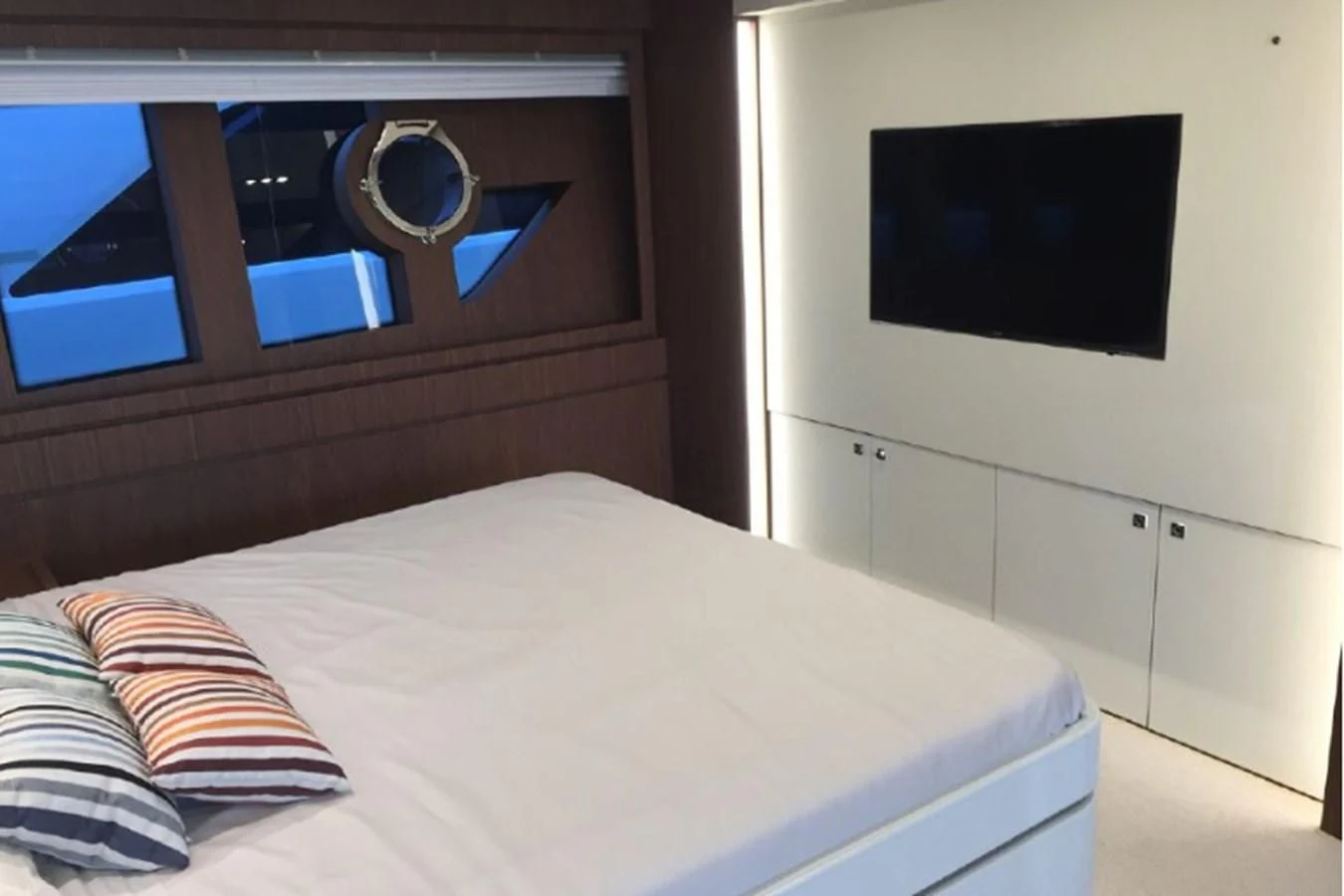 a bed with a white bed spread aboard MOIRA CINCO Yacht for Sale