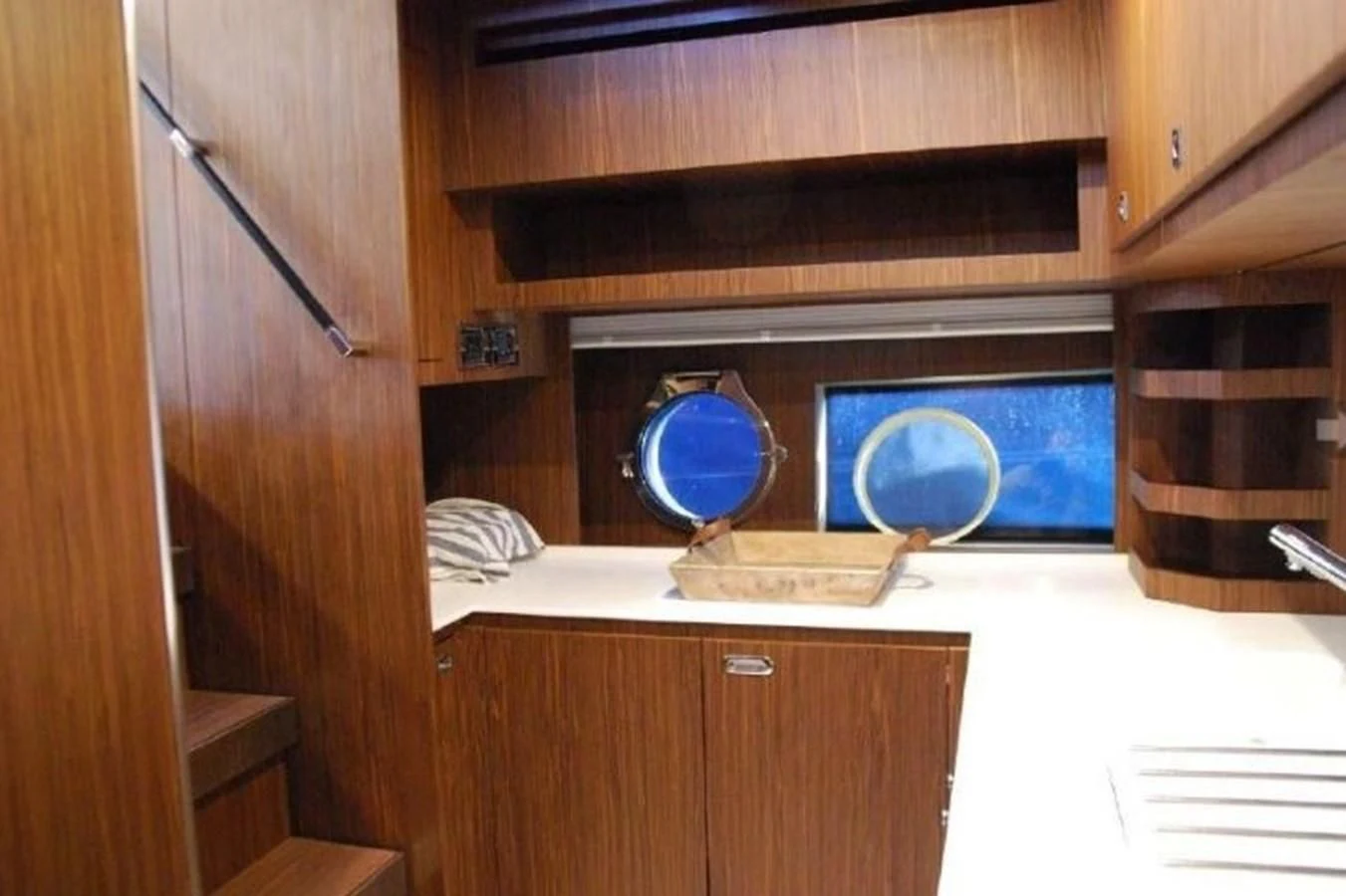 a room with a television and a cabinet with drawers aboard MOIRA CINCO Yacht for Sale