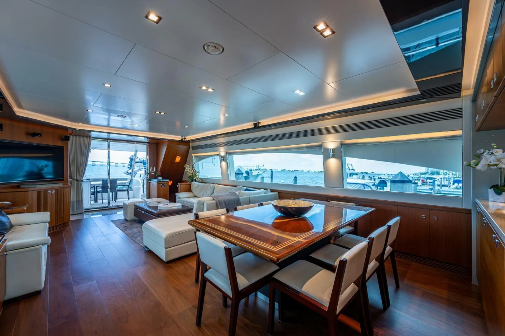 a large living room with a table and chairs aboard MOIRA CINCO Yacht for Sale
