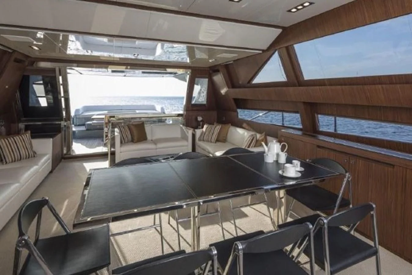 a large table with chairs around it aboard MOIRA CINCO Yacht for Sale