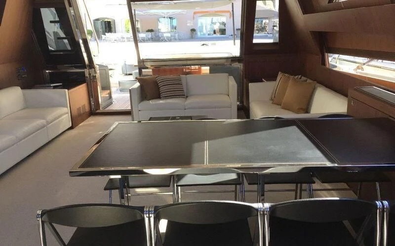 a room with a table and chairs aboard MOIRA CINCO Yacht for Sale