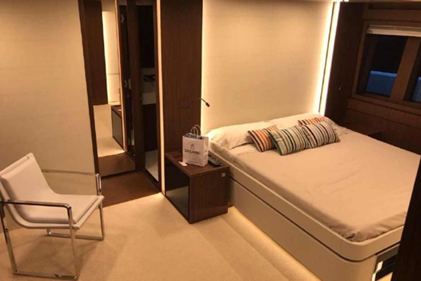 a bed and a chair in a room aboard MOIRA CINCO Yacht for Sale