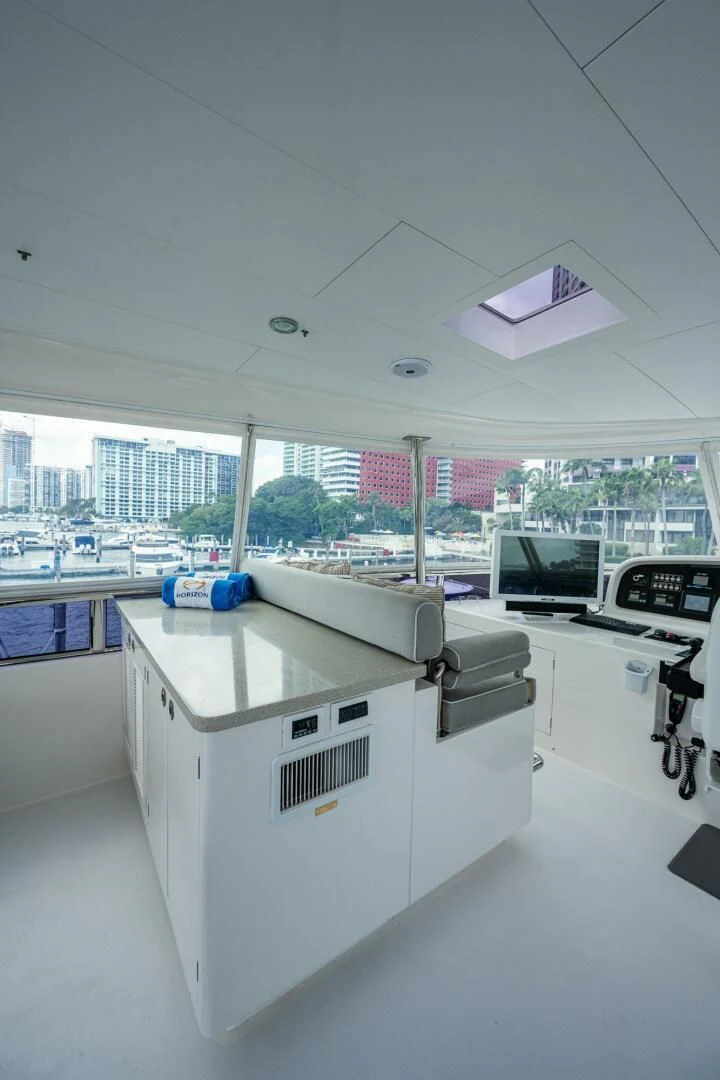 a room with a large window and a desk with a computer on it aboard MOIRA CINCO Yacht for Sale
