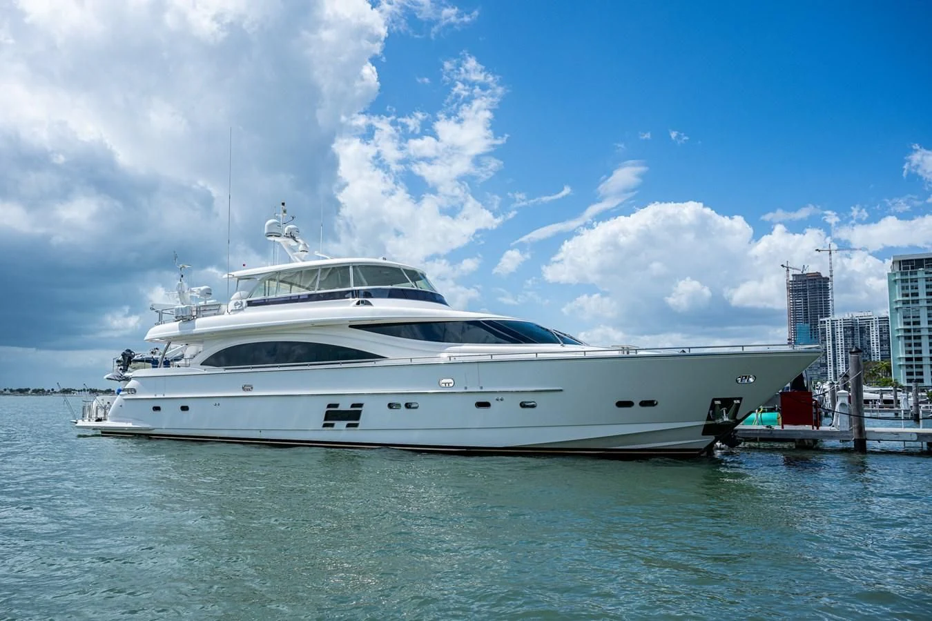 a white yacht in a harbor aboard MOIRA CINCO Yacht for Sale