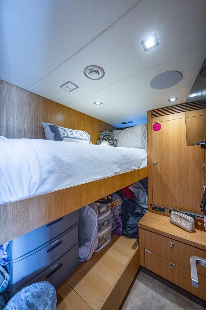 a bedroom with a bed and a dresser aboard MOIRA CINCO Yacht for Sale