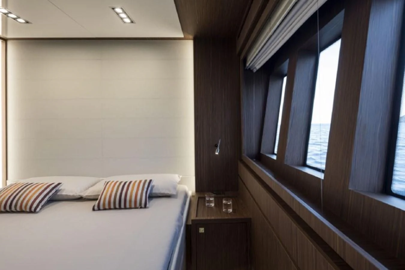 a room with a bed and a window aboard MOIRA CINCO Yacht for Sale