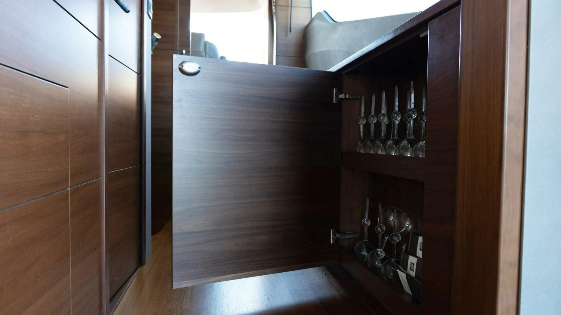 a wine cabinet with wine glasses aboard MOIRA CINCO Yacht for Sale