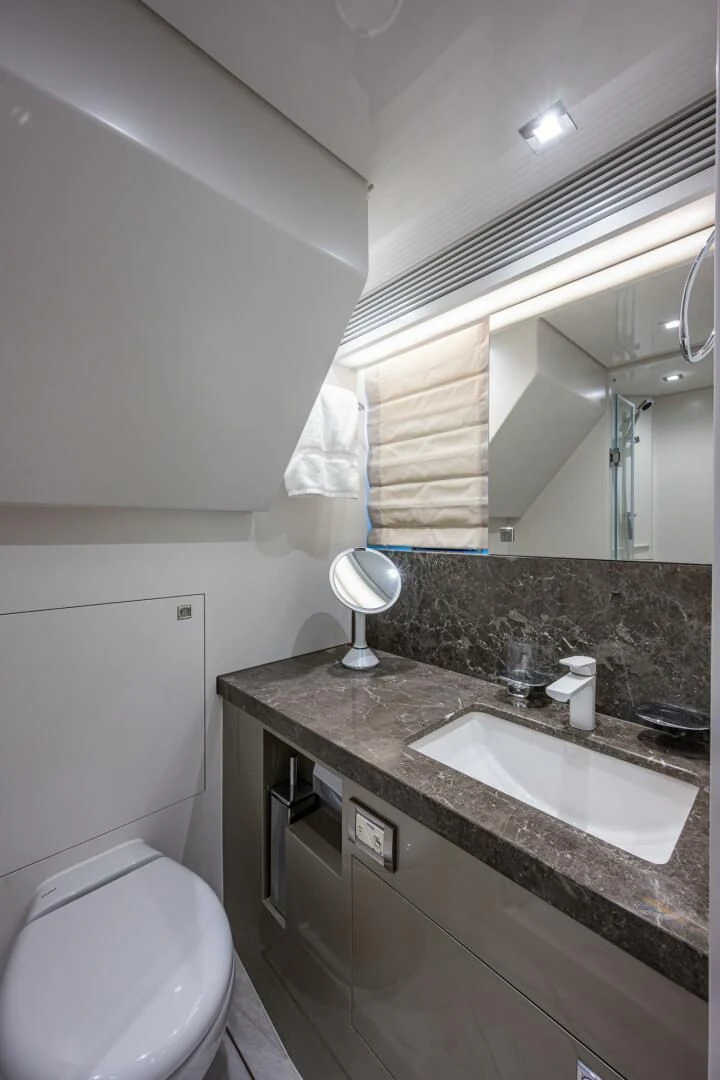 a bathroom with a sink and a mirror aboard MOIRA CINCO Yacht for Sale