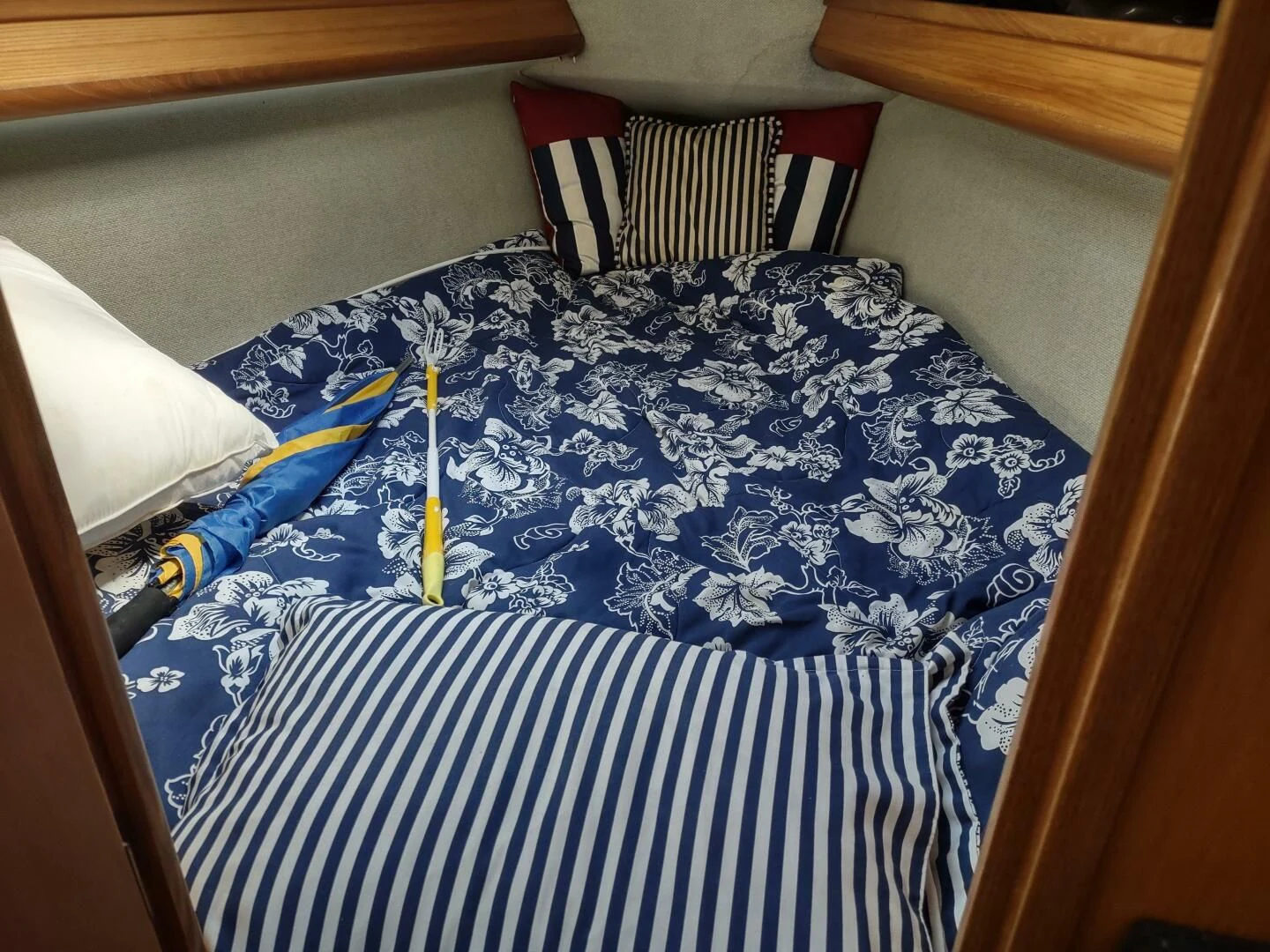 a blue and white bed with a blue and white striped pillow aboard ILLUSION XI Yacht for Sale