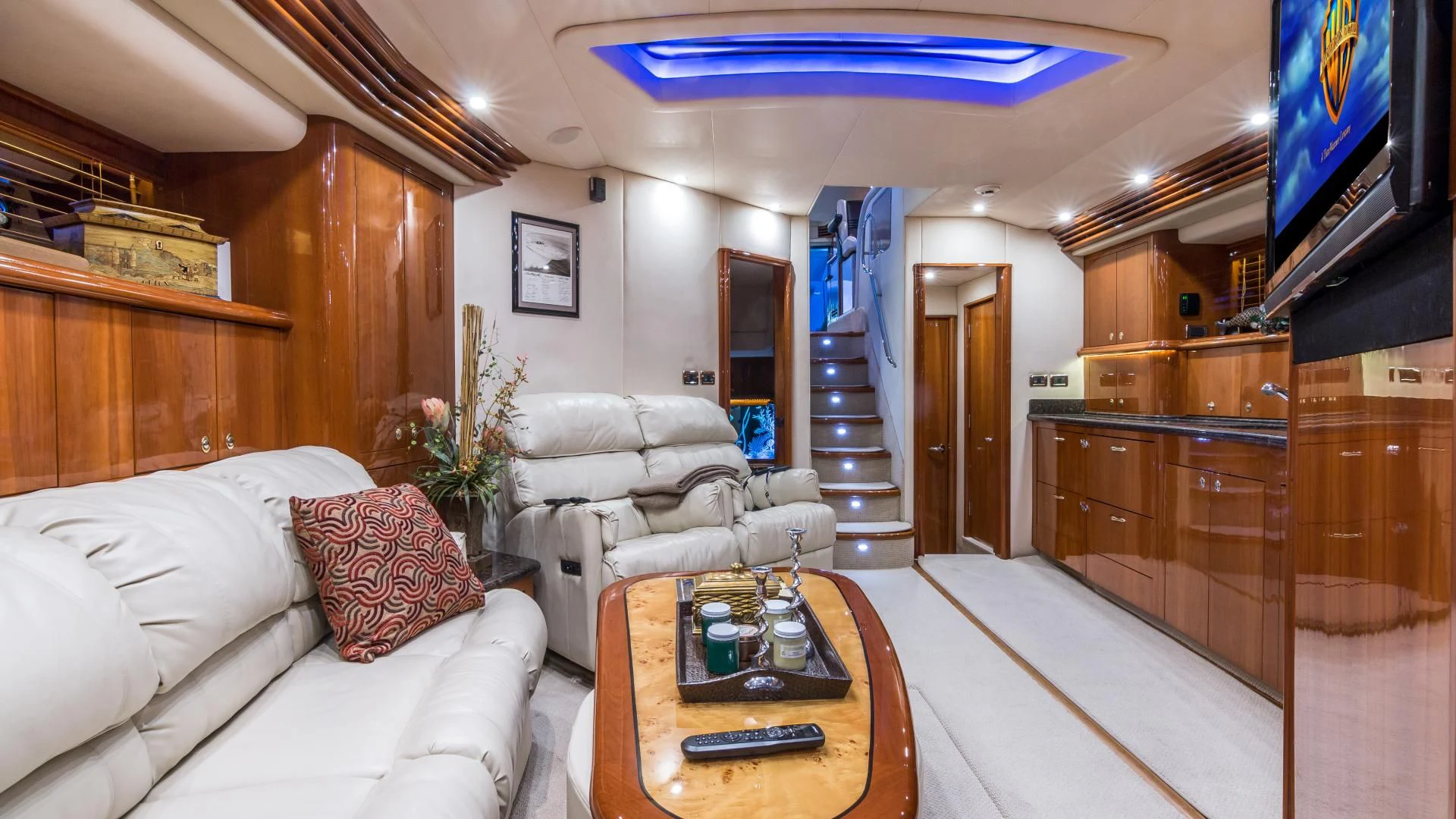 a living room with a large television aboard XANADU Yacht for Sale