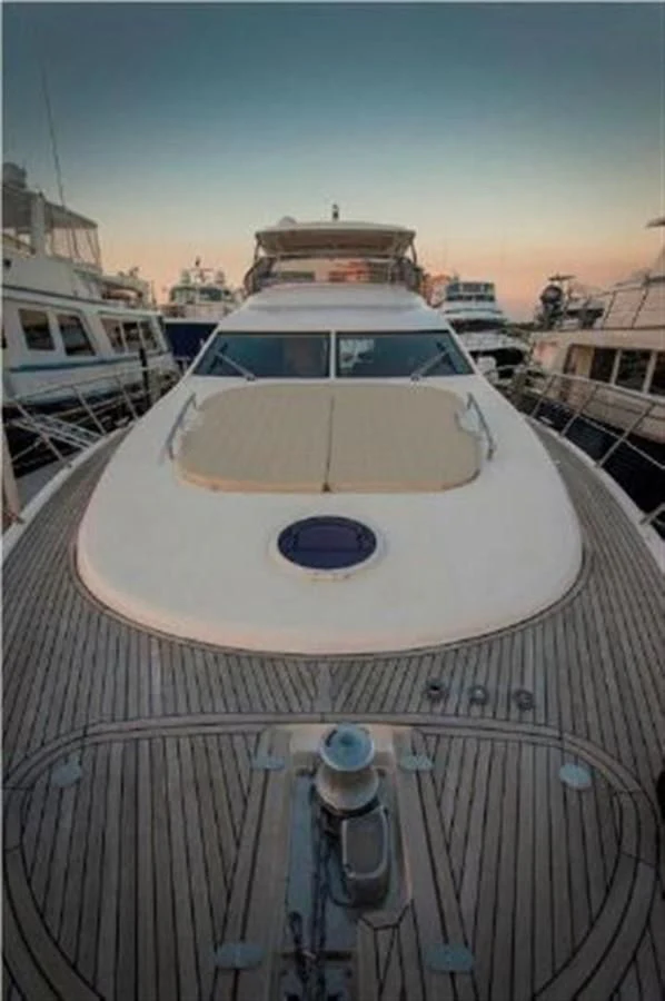 a white boat in a harbor aboard RAMAYA Yacht for Sale
