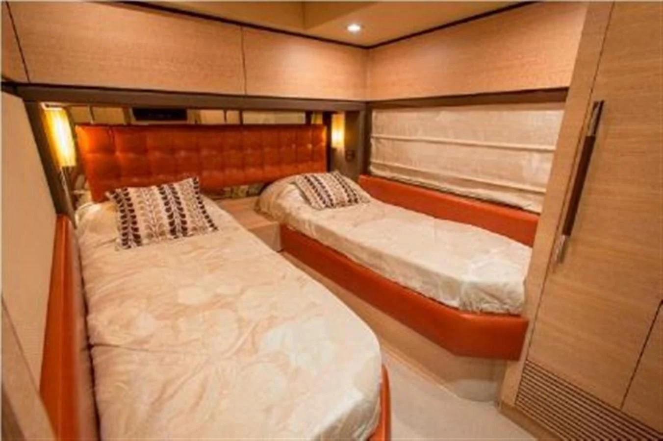 a room with beds and a window aboard RAMAYA Yacht for Sale