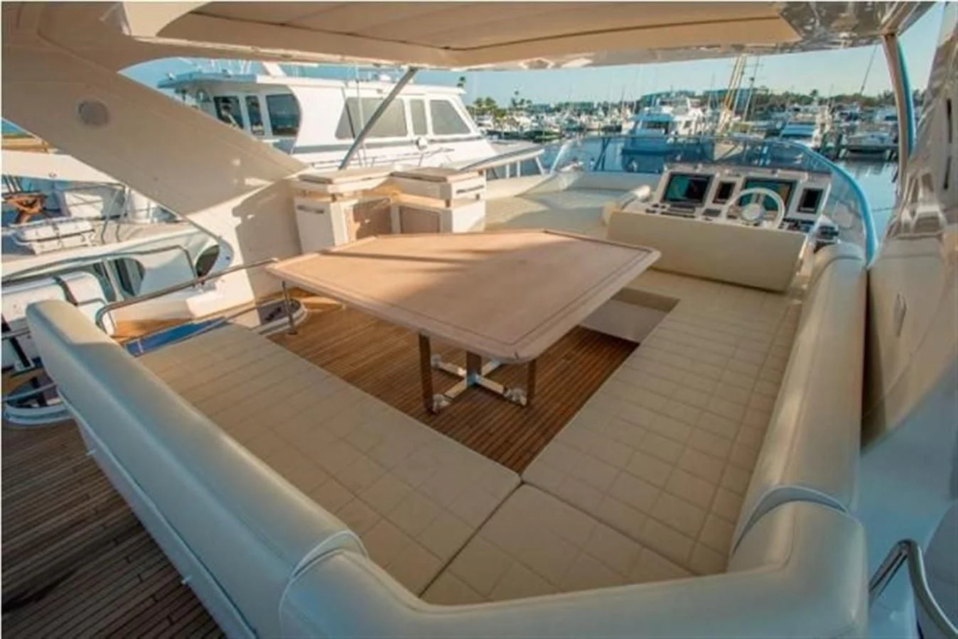 a deck with a table and boats aboard RAMAYA Yacht for Sale