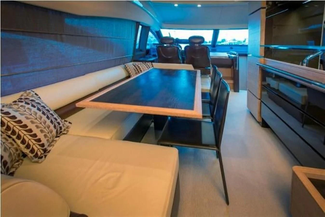 a room with a table and chairs aboard RAMAYA Yacht for Sale
