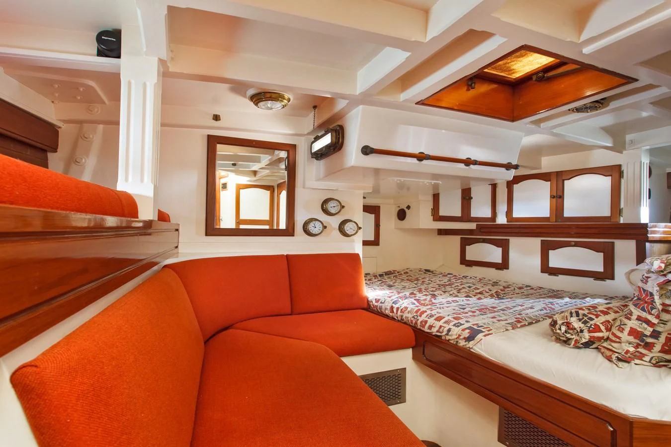 a room with a bed and a mirror aboard COPIHUE Yacht for Sale