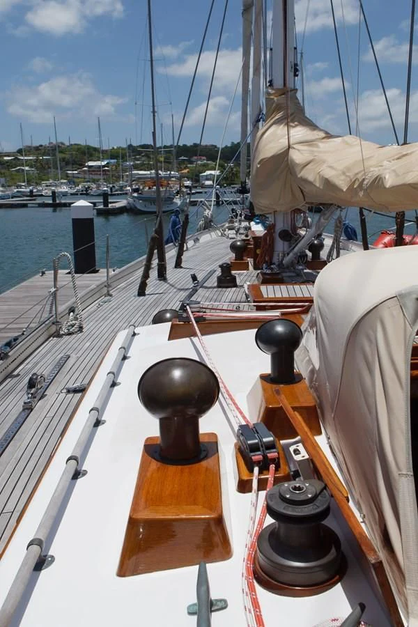 a boat with a steering wheel and a ship in the background aboard COPIHUE Yacht for Sale