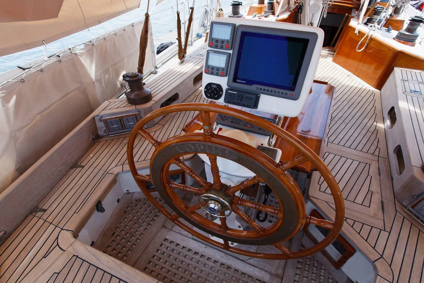 a wooden steering wheel on a boat aboard COPIHUE Yacht for Sale