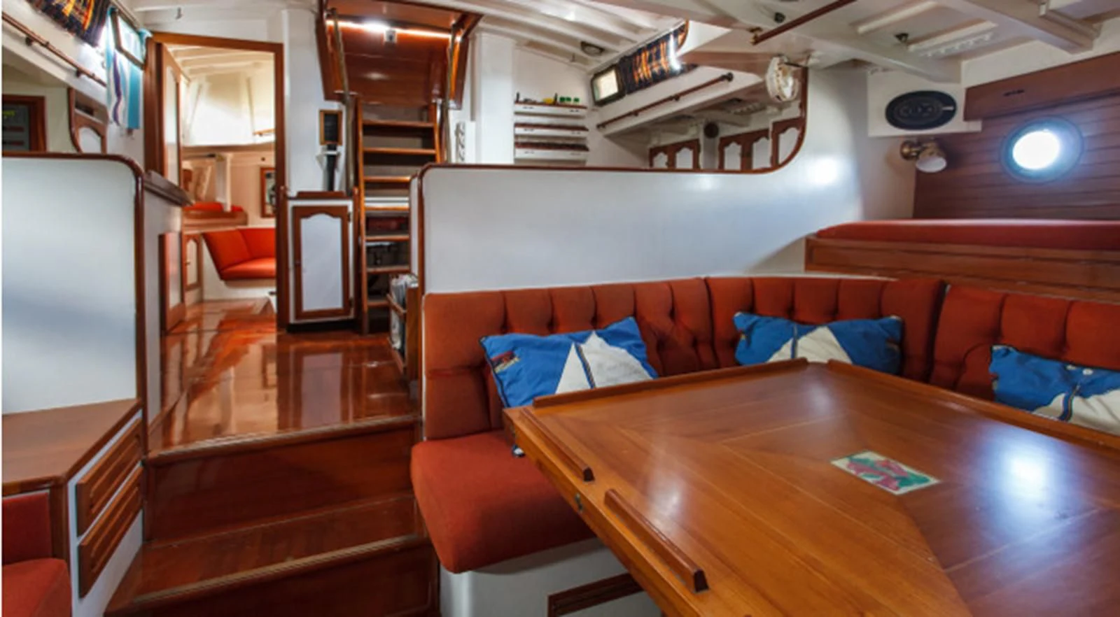 a living room with a wood table aboard COPIHUE Yacht for Sale