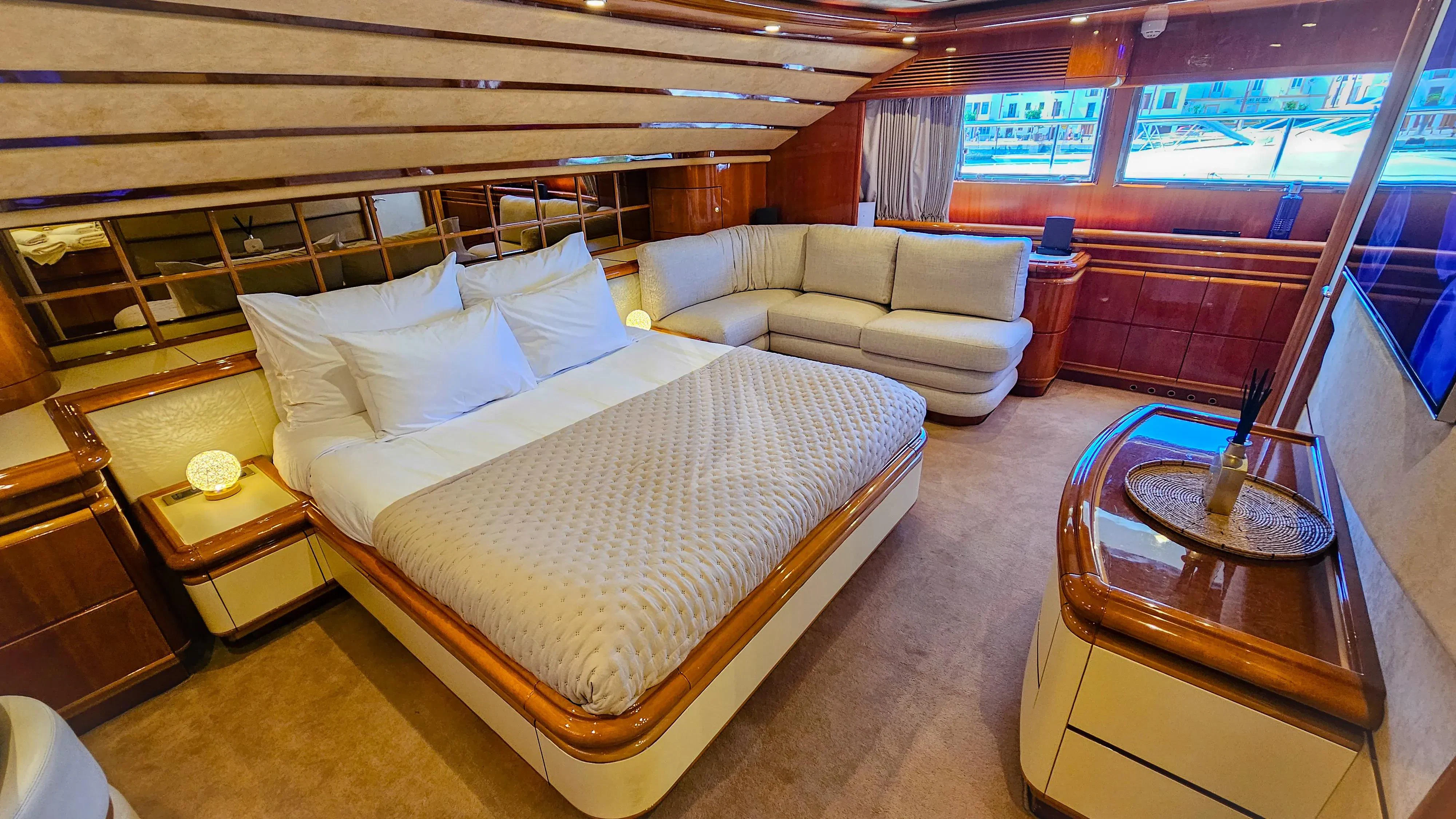 a room with a bed and a couch aboard YOLO TOO Yacht for Charter