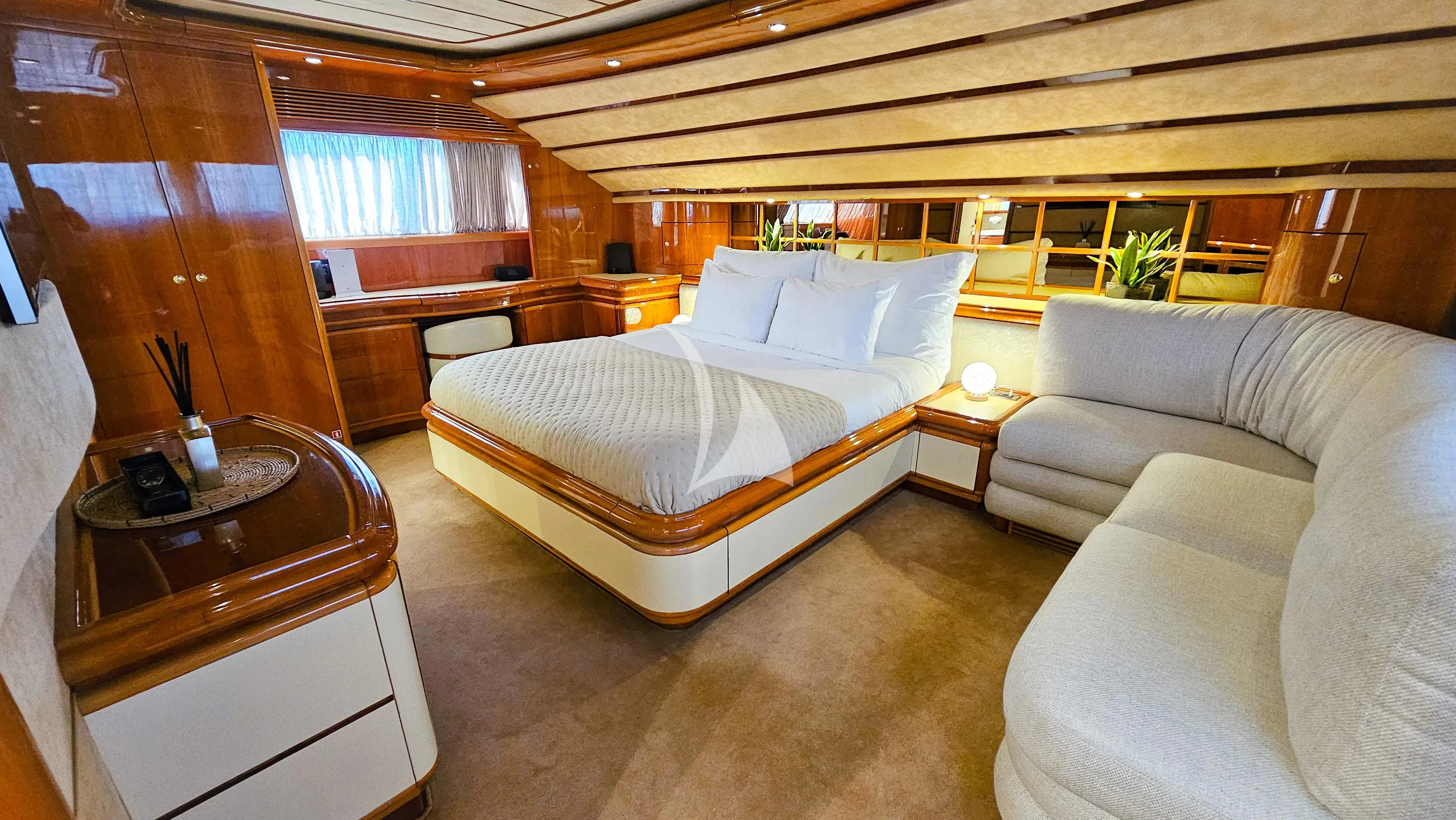 a room with a bed and a couch aboard YOLO TOO Yacht for Charter