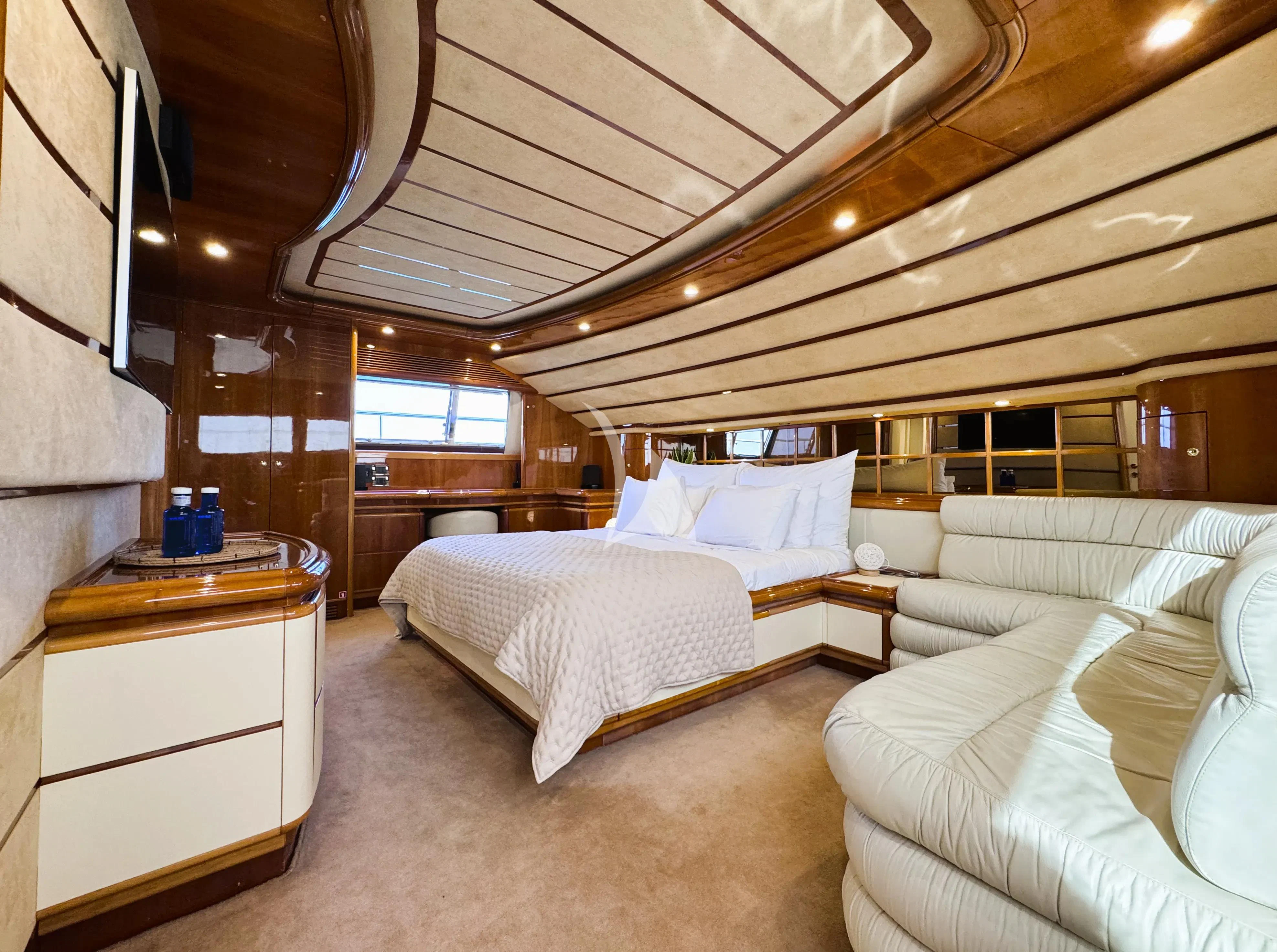a room with a bed and a couch aboard YOLO TOO Yacht for Charter