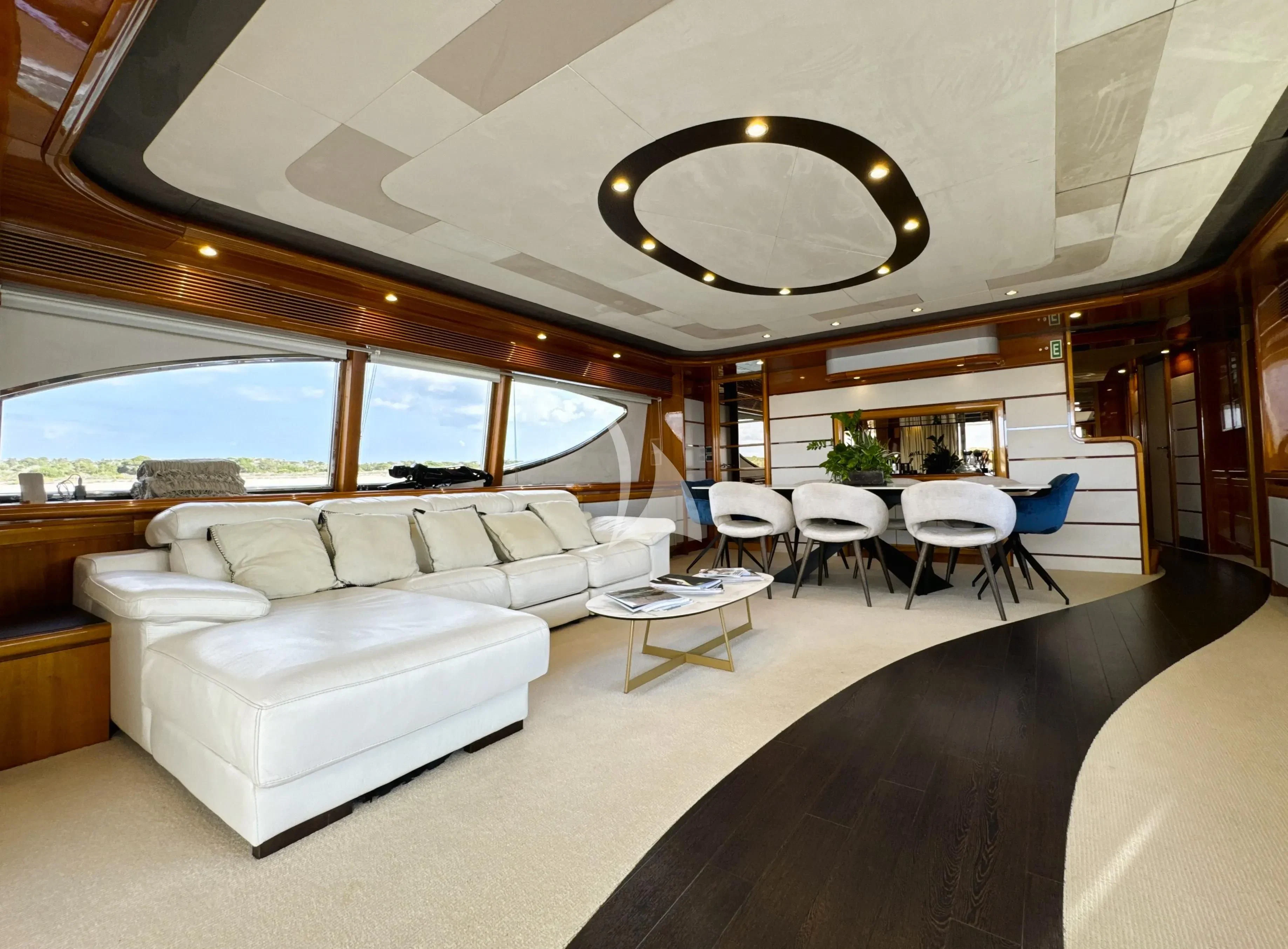 a room with a couch and a table and chairs aboard YOLO TOO Yacht for Charter