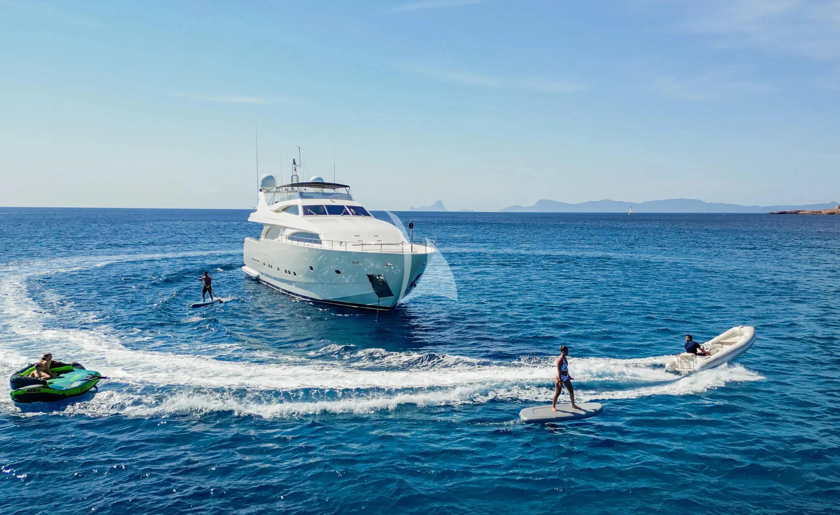 a group of people surfing in the sea aboard YOLO TOO Yacht for Charter