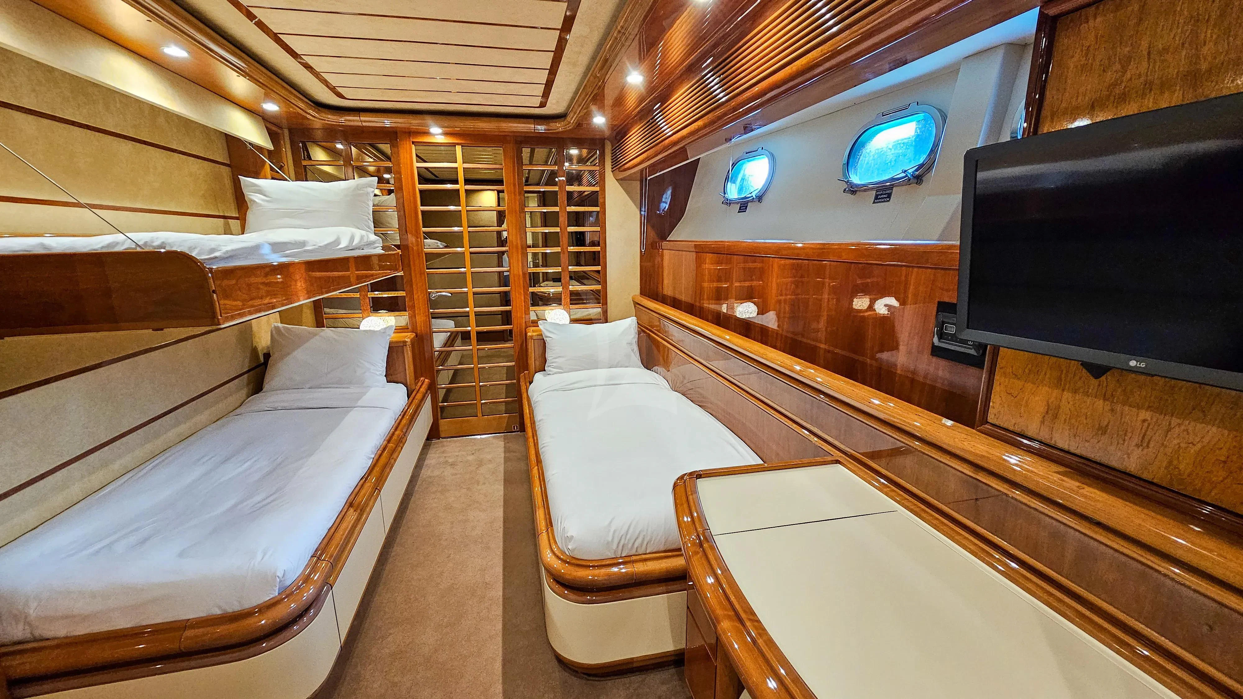 a room with a bed and a tv aboard YOLO TOO Yacht for Charter