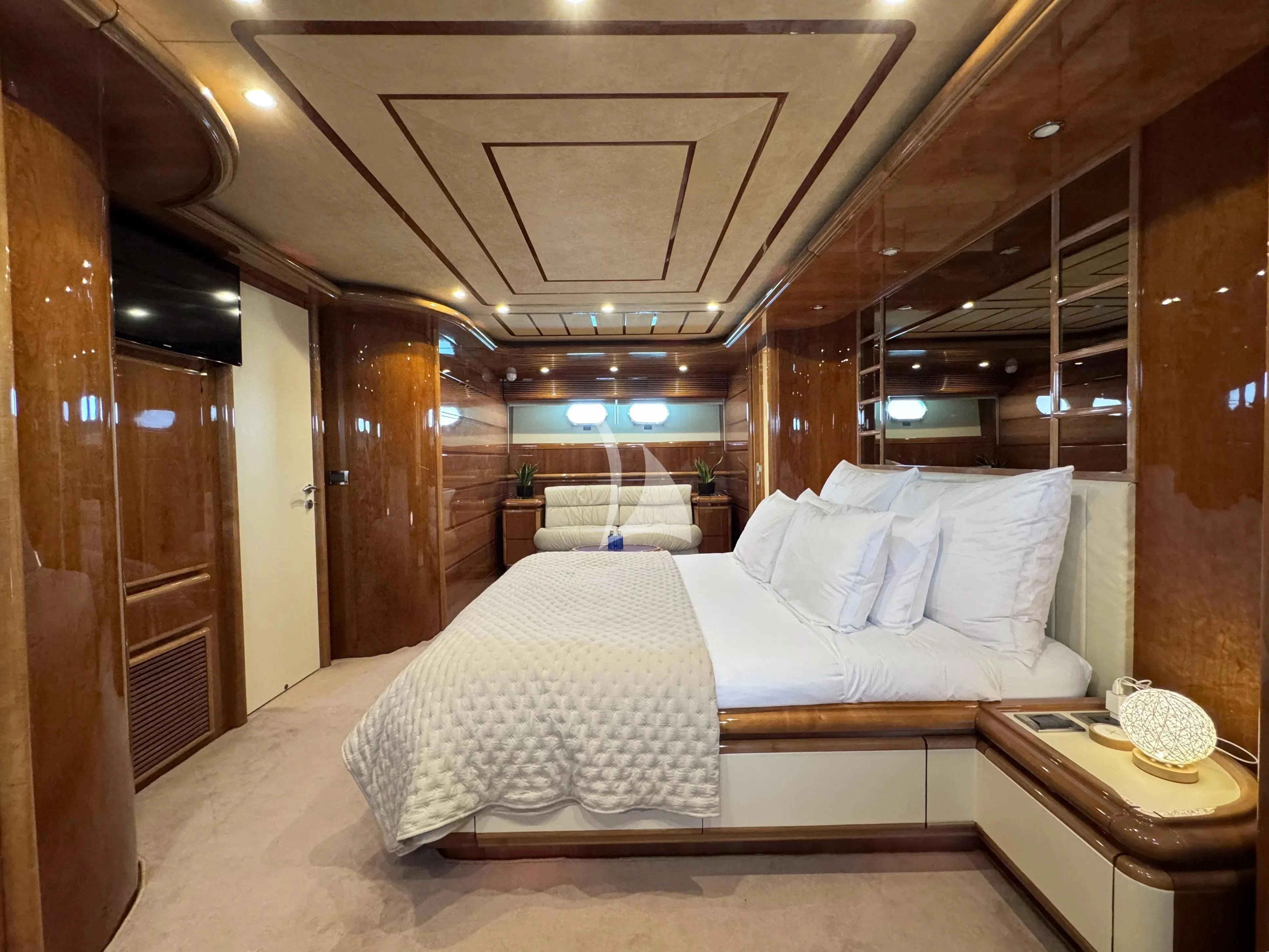 a room with a bed and a table aboard YOLO TOO Yacht for Charter