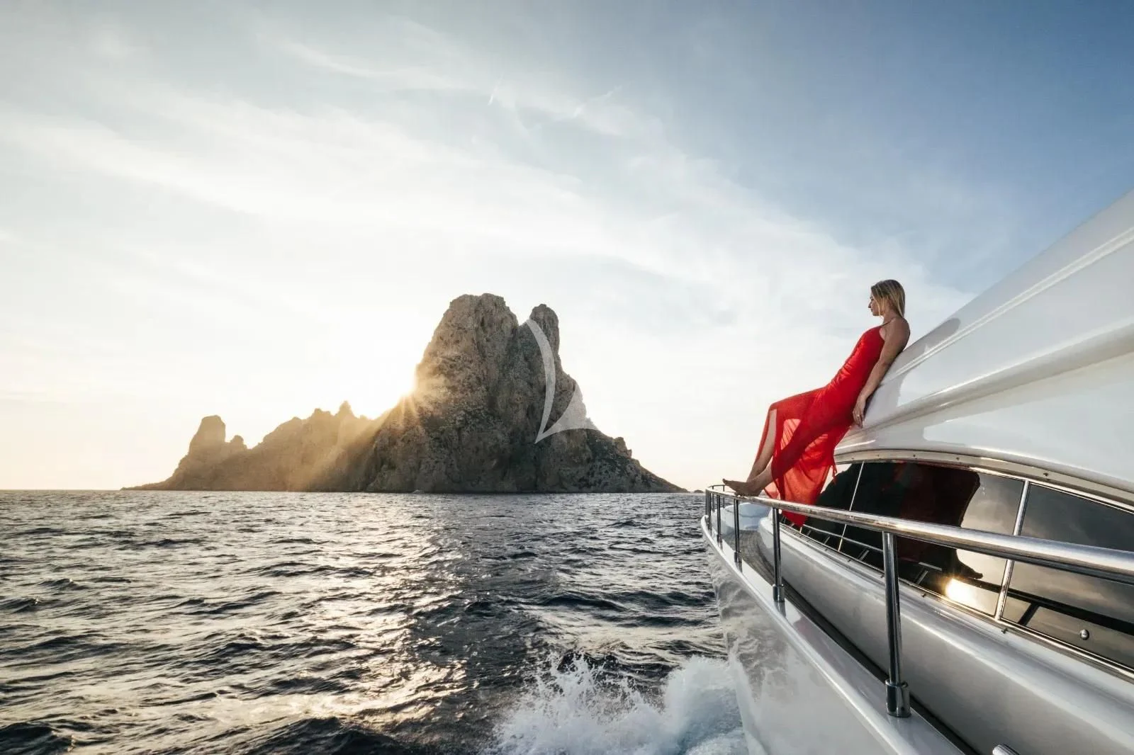 a person in a red dress on a boat in the water aboard YOLO TOO Yacht for Charter