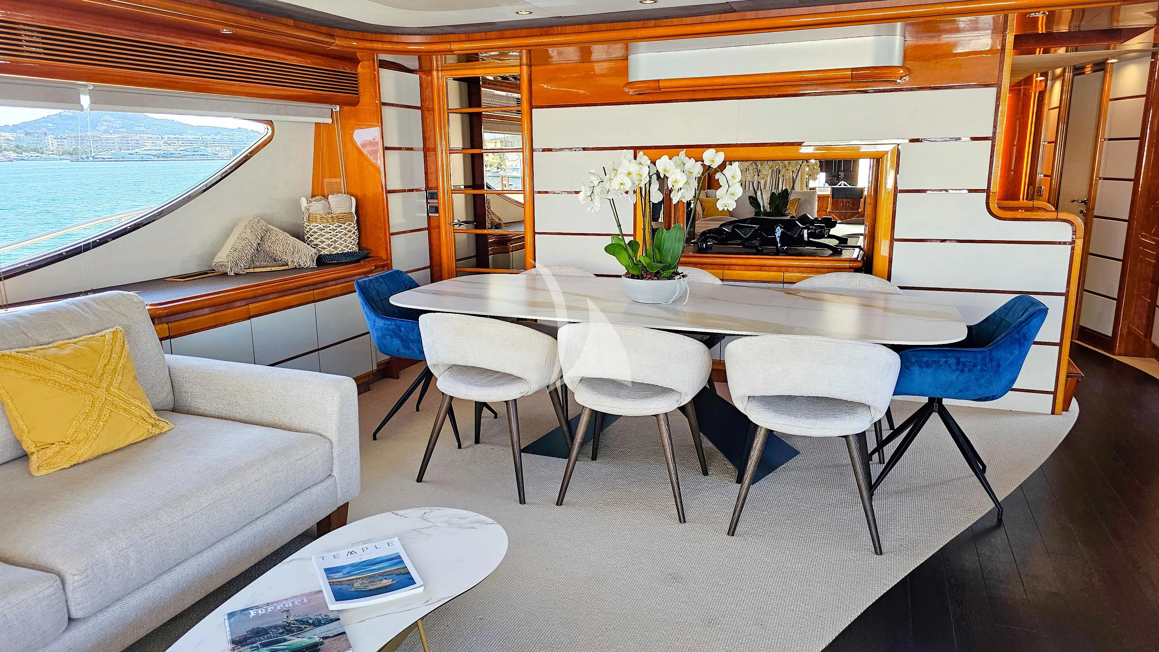 a room with a table and chairs aboard YOLO TOO Yacht for Charter