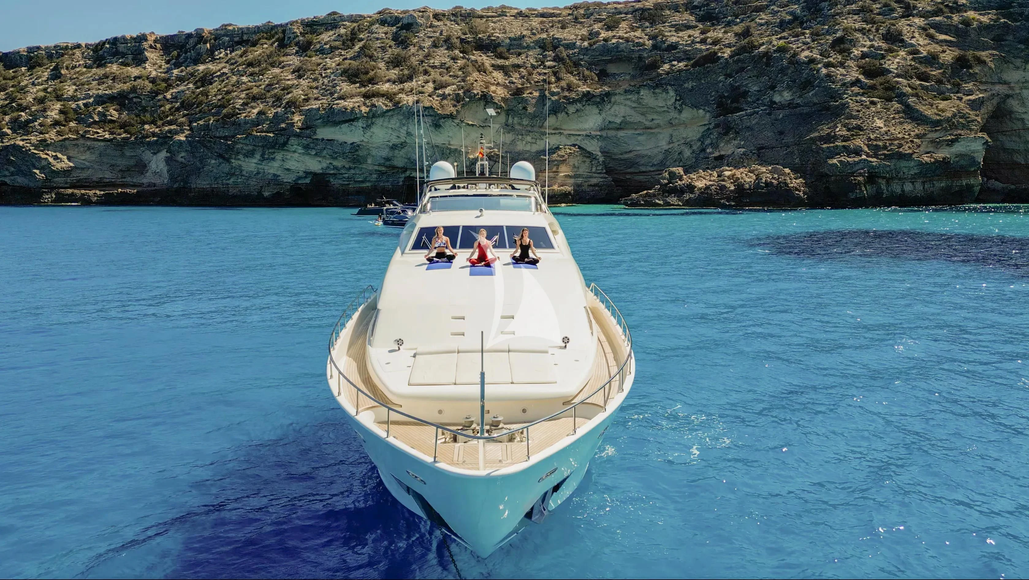 a white boat in the water aboard YOLO TOO Yacht for Charter