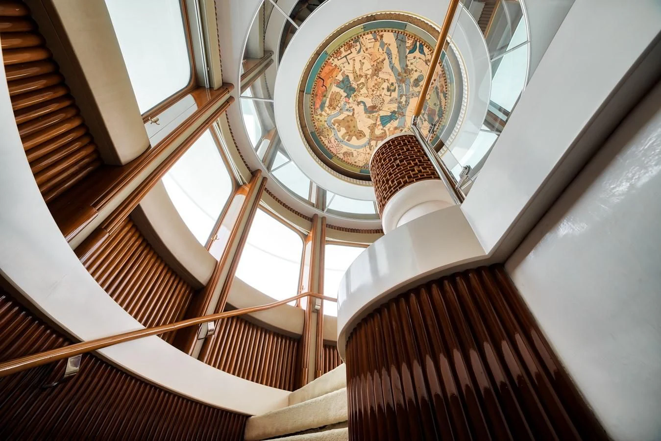a staircase with a chandelier aboard ASEAN LADY Yacht for Sale