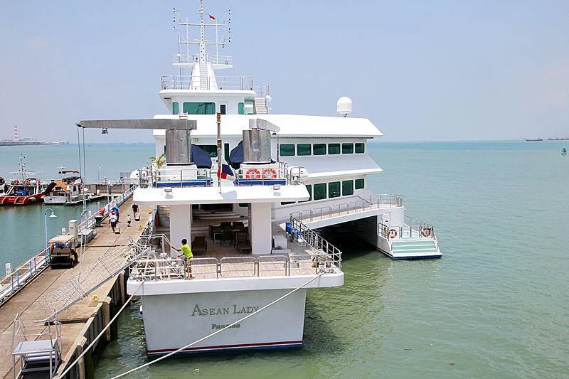 a large white boat docked at a pier aboard ASEAN LADY Yacht for Sale