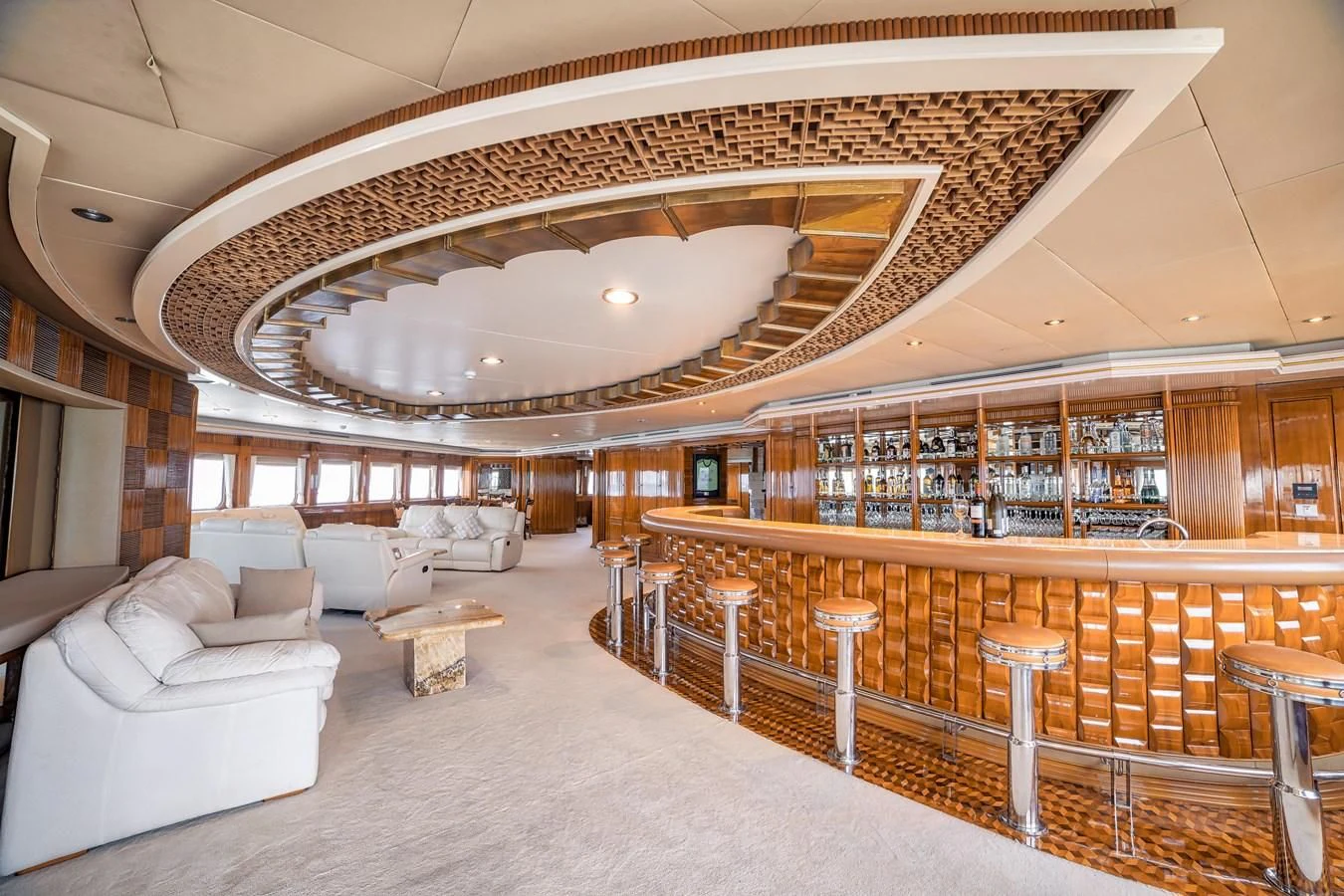 a large room with a large bar and a large table with chairs aboard ASEAN LADY Yacht for Sale